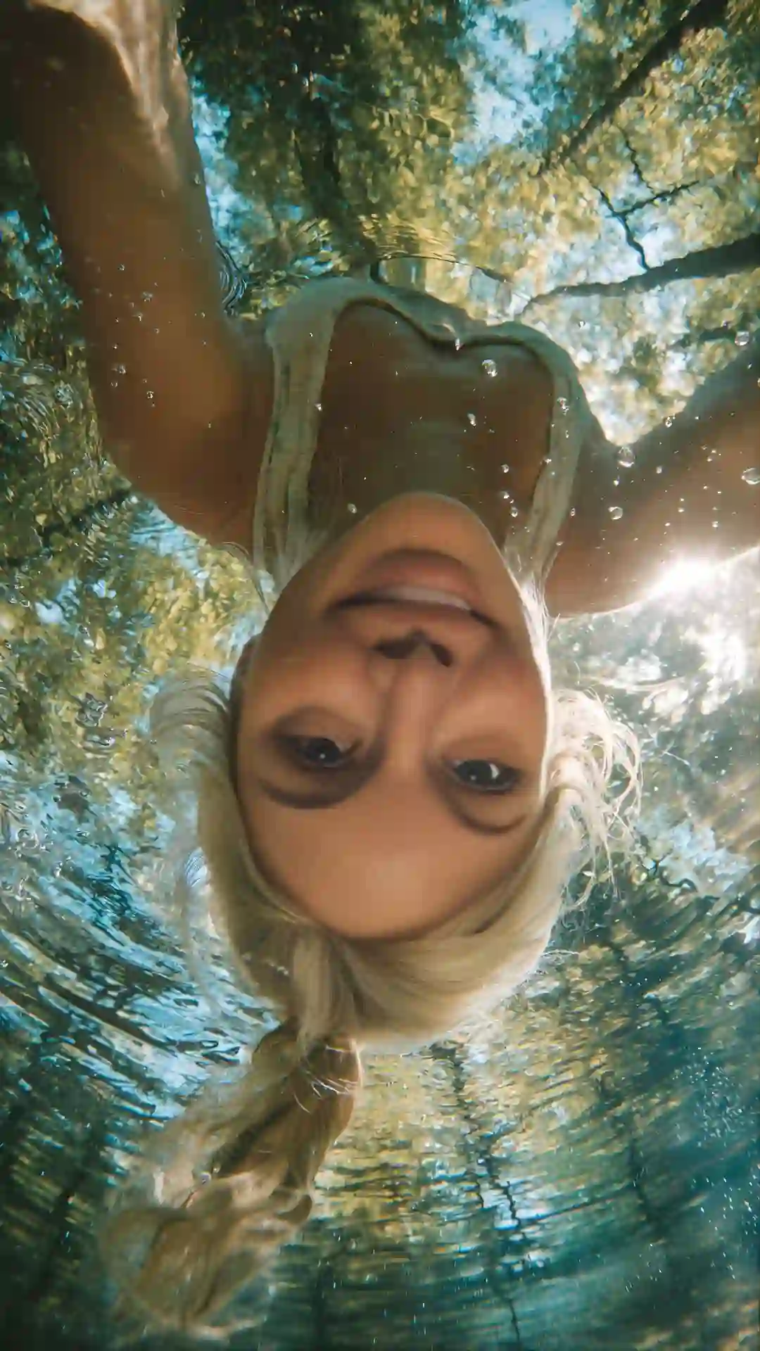 Ultimate Gemini Prompts for Girl code: a perfect submerged GoPro dome split-shot with the subject half-underwater.